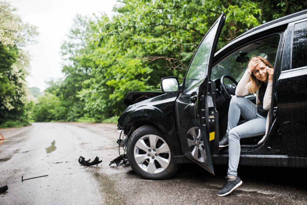 lady sitting in the car stranded after her car fender accident