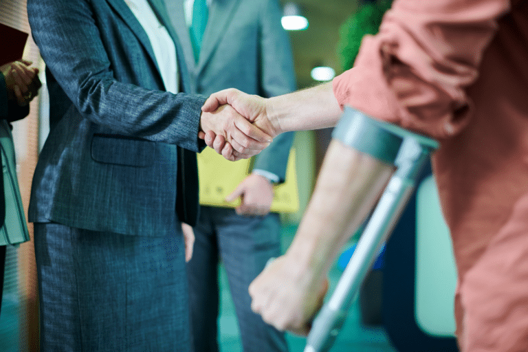 man using crutches shaking hands with a woman