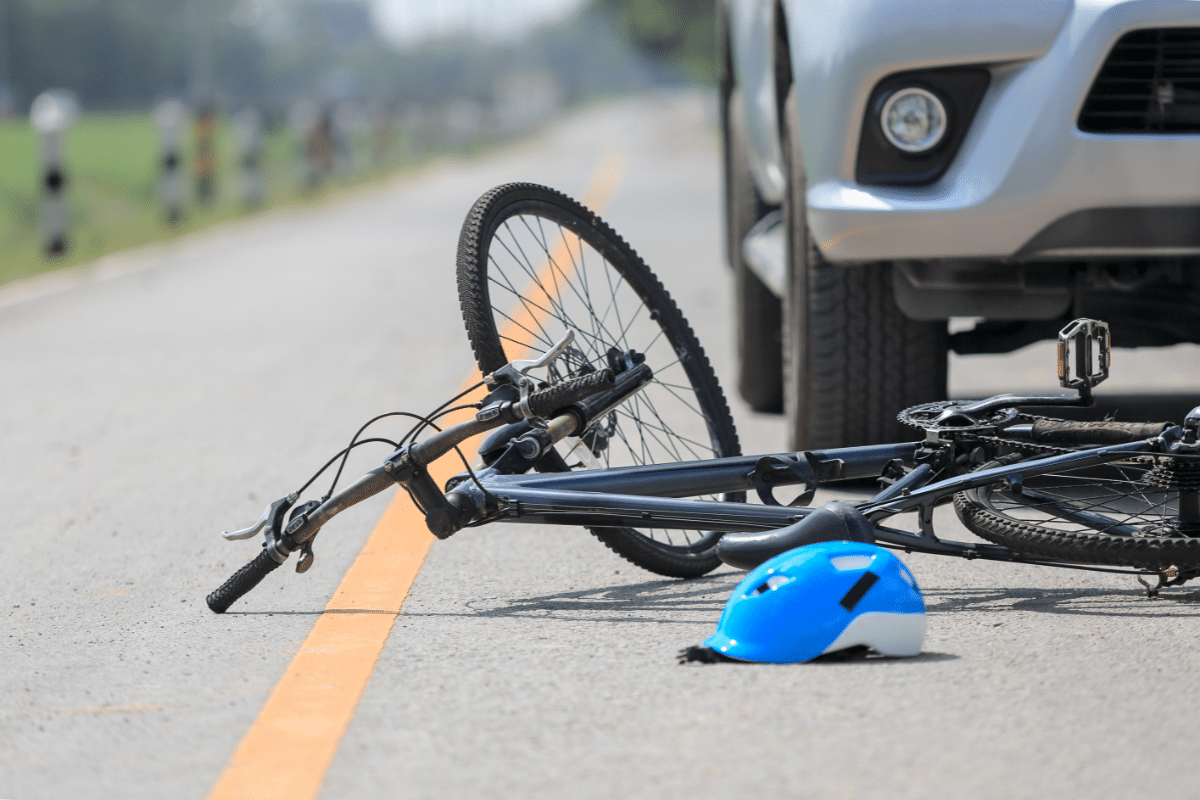 Fallen bicycle in front of a car