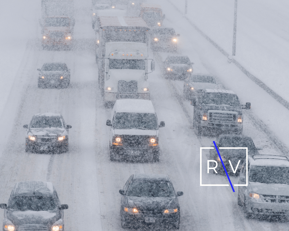 cars driving down a snowy road