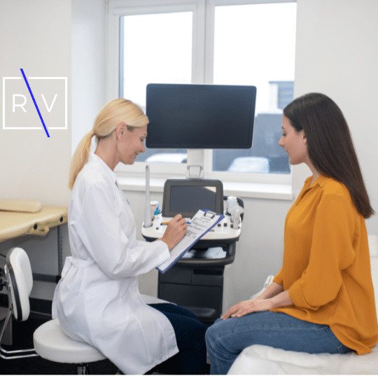 Doctor and patient. Blond doctor talking to her young dark-haired patient